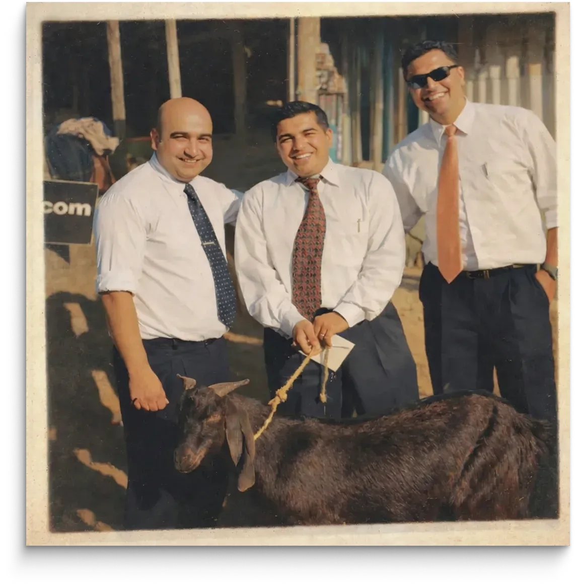 Bal Krishna Joshi and colleagues standing with a goat
